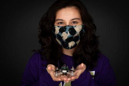 woman holding a small drone