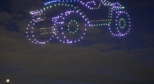 Illuminated drones light up night sky in the form of a car.