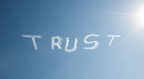 The word "Trust" in skywriting