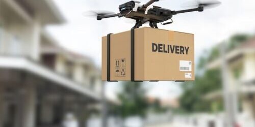 Drone carrying a box for delivery.